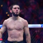 Islam Makhachev (red gloves) reacts after defeating Renato Moicano (blue gloves) in a lightweight title fight during UFC 311 at Intuit Dome.