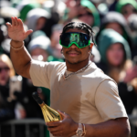 Nolan Smith Jr waves to fans during the Super Bowl LIX championship parade and rally.