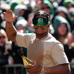 Nolan Smith Jr waves to fans during the Super Bowl LIX championship parade and rally.