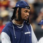 Dallas Cowboys wide receiver CeeDee Lamb watches from the sidelines during the first half against the Washington Commanders at AT&T Stadium.