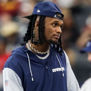 Dallas Cowboys wide receiver CeeDee Lamb watches from the sidelines during the first half against the Washington Commanders at AT&T Stadium.