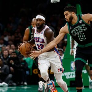 Boston Celtics forward Jayson Tatum (0) tries to steal the ball from Philadelphia 76ers guard Patrick Beverley (22) during the second quarter at TD Garden.