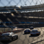 NASCAR Cup Series drivers race into turn three during the NASCAR Cup Series Championship race at Phoenix Raceway.