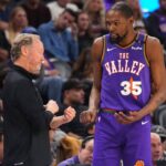 Phoenix Suns head coach Mike Budenholzer talks with Phoenix Suns forward Kevin Durant (35) against the LA Clippers during the second half at PHX Center.