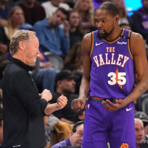 Phoenix Suns head coach Mike Budenholzer talks with Phoenix Suns forward Kevin Durant (35) against the LA Clippers during the second half at PHX Center.