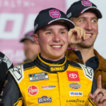 Christopher Bell (20) poses with his trophy in Victory Lane after claiming a victory at Atlanta Motor Speedway.