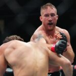 ustin Gaethje (red gloves) fights Rafael Fiziev (blue gloves) during UFC 313 at T-Mobile Arena.
