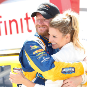 Apr 23, 2016; Richmond, VA, USA; Xfinity Series driver Dale Earnhardt Jr. (88) celebrates with his fianc Amy Reimann in Victory Lane after winning the Toyotacare 250 at Richmond International Raceway. Mandatory Credit: Amber Searls-Imagn Images