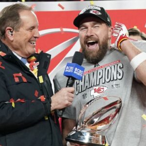 Jan 26, 2025; Kansas City, MO, USA; Kansas City Chiefs tight end Travis Kelce (87) speaks to the media after being presented with the Lamar Hunt Trophy after the AFC Championship game against the Buffalo Bills at GEHA Field at Arrowhead Stadium.