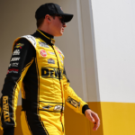 Feb 16, 2025; Daytona Beach, Florida, USA; NASCAR Cup Series driver Christopher Bell (20) walks to the drivers meeting before the Daytona 500 at Daytona International Speedway. Mandatory Credit: Peter Casey-Imagn Images
