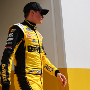 Feb 16, 2025; Daytona Beach, Florida, USA; NASCAR Cup Series driver Christopher Bell (20) walks to the drivers meeting before the Daytona 500 at Daytona International Speedway. Mandatory Credit: Peter Casey-Imagn Images