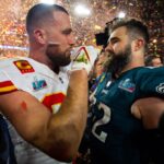 Kansas City Chiefs tight end Travis Kelce (87) talks with his brother Philadelphia Eagles center Jason Kelce (62) after Super Bowl LVII at State Farm Stadium.