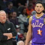 Phoenix Suns head coach Mike Budenholzer looks on alongside Phoenix Suns guard Devin Booker (1) against the Utah Jazz during the first half at Footprint Center.