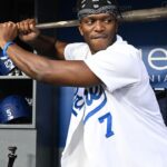 British YouTuber KSI and cruiserweight professional boxer swings a bat in the dugout prior to the game between the Los Angeles Dodgers and the Arizona Diamondbacks at Dodger Stadium.