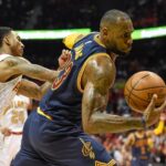Cleveland Cavaliers forward LeBron James (23) is fouled by Atlanta Hawks guard Jeff Teague (0) during the second half in game three of the second round of the NBA Playoffs at Philips Arena. The Cavaliers defeated the Hawks 121-108.