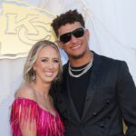 Kansas City Chiefs quarterback Patrick Mahomes and wife Brittany pose for a photo on the red carpet at the Nelson Art Gallery.