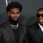Deion Sanders (right) with his son Shedeur Sanders on the red carpet before Super Bowl LIX NFL Honors at Saenger Theatre.