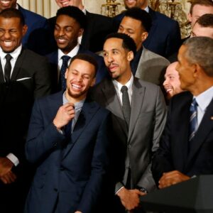 Golden State Warriors guard Stephen Curry (M) laughs with teammates as President Barack Obama speaks during a ceremony honoring the 2015 NBA Champion Warriors in the East Room at the White House
