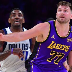 Los Angeles Lakers guard Luka Doncic (77) and Dallas Mavericks guard Kyrie Irving (11) attempt to gain control during the first quarter at Crypto.com Arena.