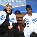 A; American YouTuber Logan Paul and British YouTuber KSI, both cruiserweight professional boxers, pose for photos in the dugout prior to the game between the Los Angeles Dodgers and the Arizona Diamondbacks at Dodger Stadium
