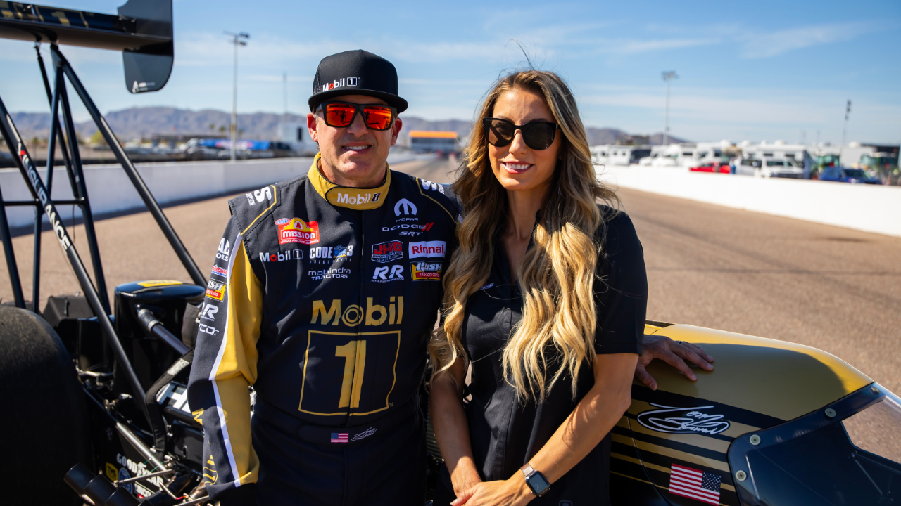 NHRA top fuel driver Tony Stewart (left) and wife Leah Pruett pose for a portrait prior to the Arizona Nationals at Firebird Motorsports Park.