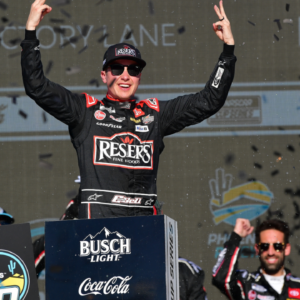 Mar 9, 2025; Avondale, Arizona, USA; NASCAR Cup Series driver Christopher Bell (20) celebrates his victory of the Shriners Children’s 500 at Phoenix Raceway. Mandatory Credit: Gary A. Vasquez-Imagn Images