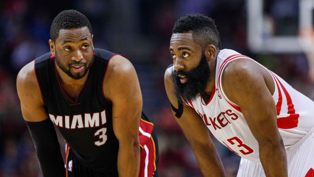 Miami Heat guard Dwyane Wade (3) and Houston Rockets guard James Harden (13) talk during the second quarter at Toyota Center.