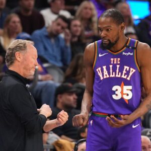 Phoenix Suns head coach Mike Budenholzer talks with Phoenix Suns forward Kevin Durant (35) against the LA Clippers during the second half at PHX Center.