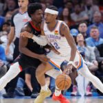 Mar 3, 2025; Oklahoma City, Oklahoma, USA; Oklahoma City Thunder guard Shai Gilgeous-Alexander (2) drives to the baskets against Houston Rockets guard Aaron Holiday (0) during the second half at Paycom Center. Mandatory Credit: Alonzo Adams-Imagn Images