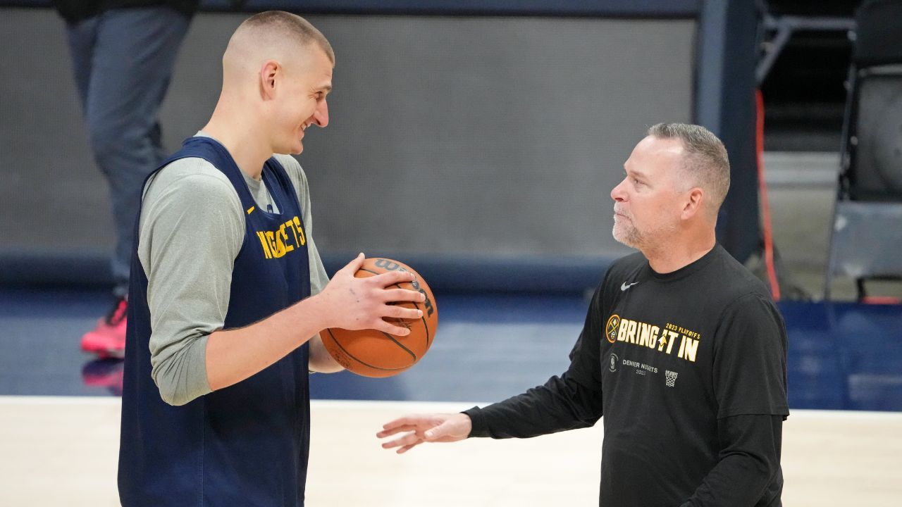 Denver Nuggets center Nikola Jokic (15) talks with head coach Michael Malone during a practice session on media day before the 2023 NBA Finals at Ball Arena.