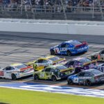 Ryan Blaney (12) and Ross Chastain (1) are part of the lead pack seconds before their wreck in the final laps during the second stage of the YellaWood 500 at Talladega Superspeedway.
