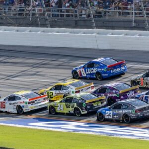 Ryan Blaney (12) and Ross Chastain (1) are part of the lead pack seconds before their wreck in the final laps during the second stage of the YellaWood 500 at Talladega Superspeedway.