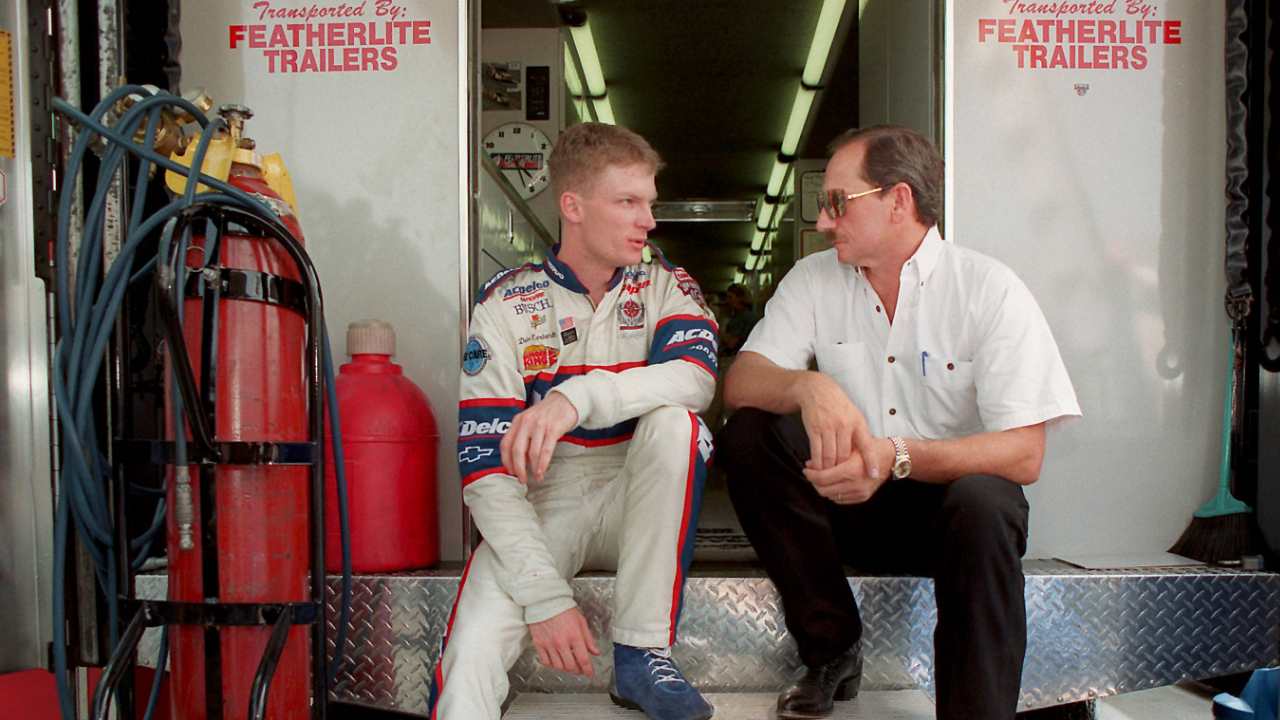 Dale Earnhardt Jr. and Dale Earnhardt Sr., sit on the back of a transporter discussing Earnhardt Jr. s preparation for Carquest 300 Grand National qualifications on May 21, 1998 in Concord, North Carolina. (Jeff Siner Charlotte Observer MCT) CONCORD NC USA EDITORIAL USE ONLY Copyright: xx 1043949 JEFFxSINERx krtphotoslive254715