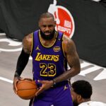 Los Angeles Lakers forward LeBron James (23) and Dallas Mavericks forward Naji Marshall (13) in action during the game between the Dallas Mavericks and the Los Angeles Lakers at American Airlines Center.