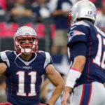 New England Patriots receiver Julian Edelman (11) talks with quarterback Tom Brady prior to the game against the Dallas Cowboys at AT&T Stadium.