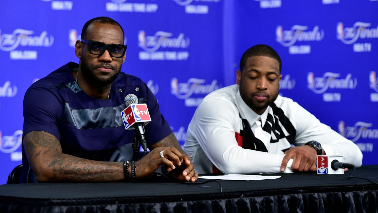 Miami Heat forward LeBron James (6) and guard Dwyane Wade (3) speak during a press conference after game five of the 2014 NBA Finals at AT&T Center.