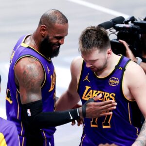 Los Angeles Lakers forward LeBron James (23) celebrates with Los Angeles Lakers guard Luka Doncic (77) during the fourth quarter against the Dallas Mavericks at American Airlines Center