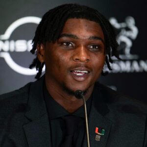 Miami Hurricanes quarterback Cam Ward speaks on stage during a press conference before the 2024 Heisman Trophy Presentation.