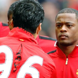 Manchester Uniteds Patrice Evra (R) shakes hands with Liverpools Luis Suarez before kick off .