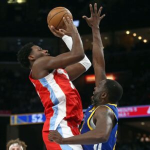 Memphis Grizzlies forward Jaren Jackson Jr. (13) shoots as Golden State Warriors forward Draymond Green (23) defends during the second quarter at FedExForum.