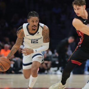 Memphis Grizzlies guard Ja Morant (12) drives to the basket past Miami Heat guard Pelle Larsson (9) during the first quarter at Kaseya Center.
