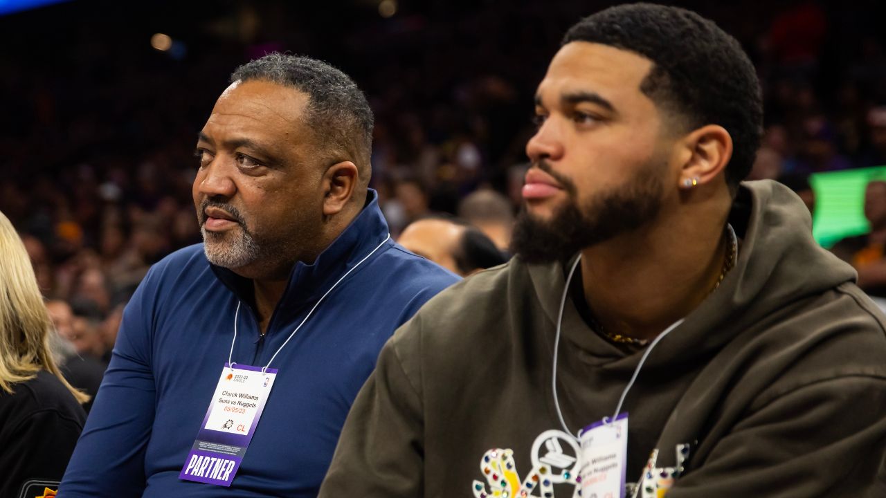 Southern California Trojans quarterback Caleb Williams (right) with father Chuck Williams in attendance during the Phoenix Suns against the Denver Nuggets during game three of the 2023 NBA playoffs at Footprint Center.