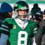 Dec 22, 2024; East Rutherford, New Jersey, USA; New York Jets quarterback Aaron Rodgers (8) talks with head coach Jeff Ulbrich during the first half against the Los Angeles Rams at MetLife Stadium.