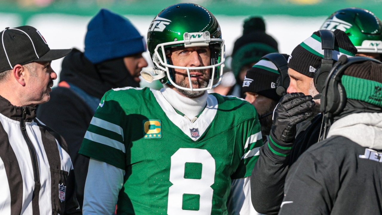 Dec 22, 2024; East Rutherford, New Jersey, USA; New York Jets quarterback Aaron Rodgers (8) talks with head coach Jeff Ulbrich during the first half against the Los Angeles Rams at MetLife Stadium.