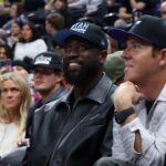 Former NBA player Dwayne Wade and Utah Jazz owner Ryan Smith watch the game between the Utah Jazz and the Phoenix Suns during the fourth quarter at Delta Center.