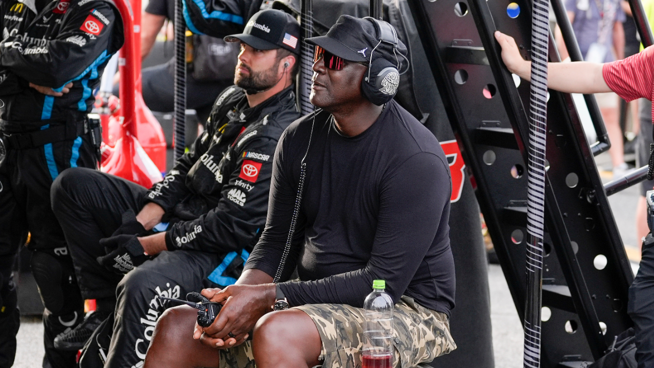 Apr 6, 2025; Darlington, South Carolina, USA; NASCAR Cup Series driver Tyler Reddick (45) team owner Michael Jordan watches his racer during the Goodyear 400 at Darlington Raceway. Mandatory Credit: Jim Dedmon-Imagn Images