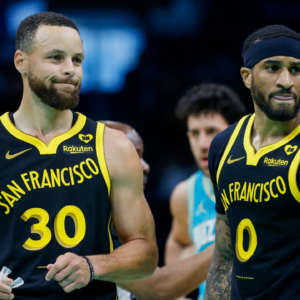 Mar 29, 2024; Charlotte, North Carolina, USA; Golden State Warriors guards Stephen Curry (30) and Gary Payton II look to the bench during a break in the action against the Charlotte Hornets during the first quarter at Spectrum Center.