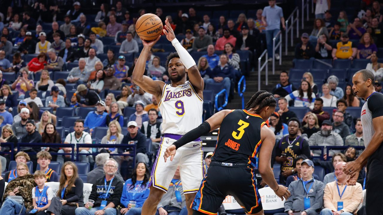 Los Angeles Lakers guard Bronny James (9) passes around Oklahoma City Thunder forward Dillon Jones (3) during the second half at Paycom Center