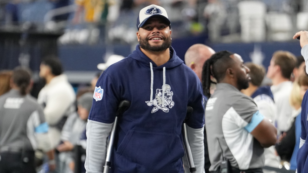 Dallas Cowboys quarterback Dak Prescott (left) stands on crutches before the game against the New York Giants at AT&T Stadium.