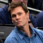 Nov 27, 2024; Dallas, Texas, USA; Former NFL quarterback Tom Brady watches the game between the Dallas Mavericks and the New York Knicks during the second quarter at the American Airlines Center.